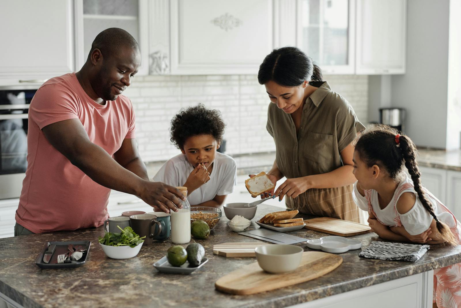 Family making breakfast together in a warm kitchen