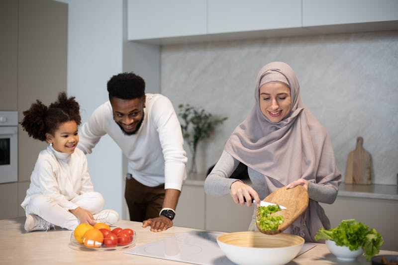Parent and child preparing food together in the kitchen