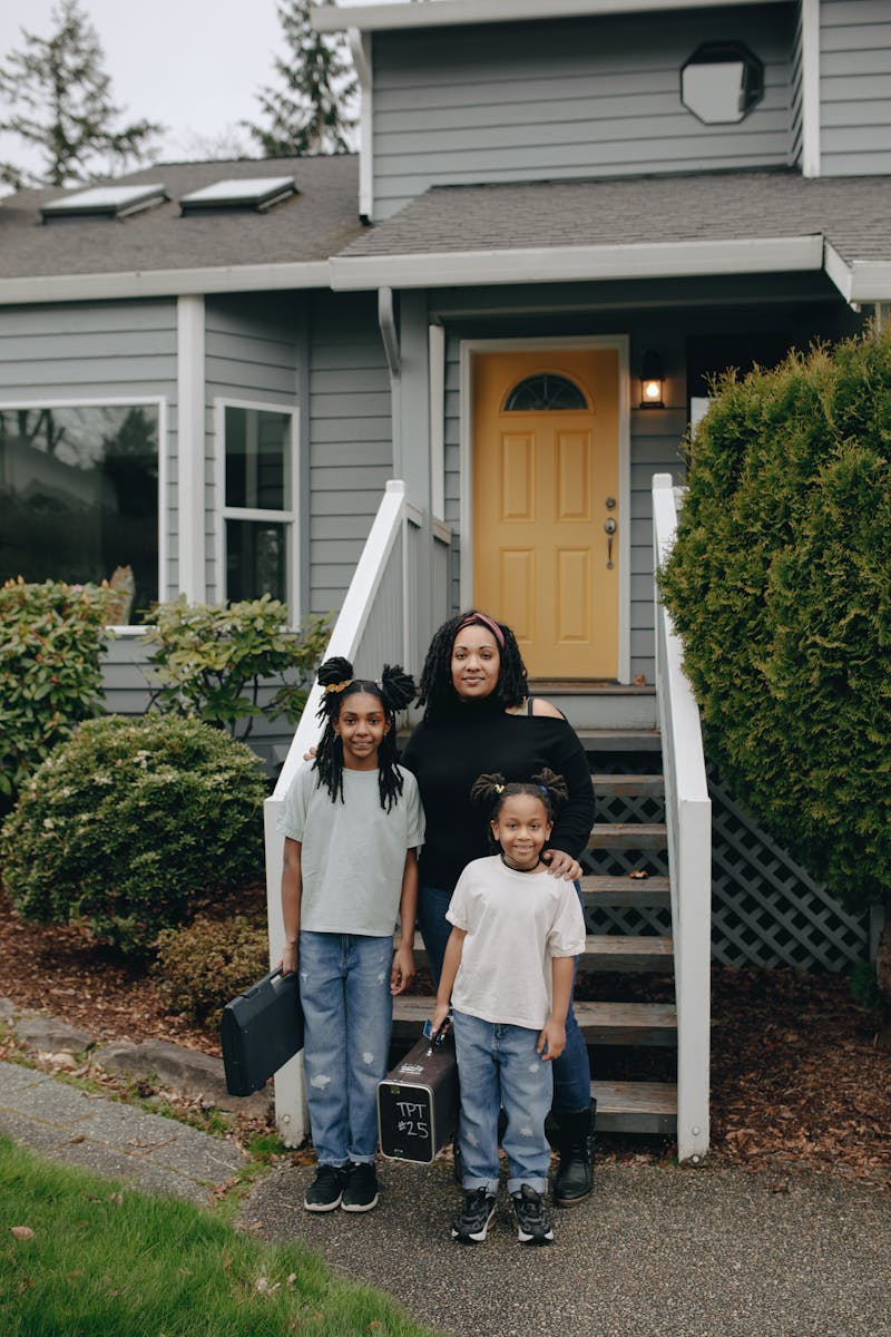 Family standing together outside their home, organized and ready